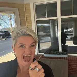 Janie Budnick holding key to Cattails Luxury Cat Lodge in St. Louis, MO